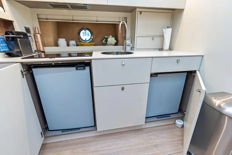 Minion Yacht Photos Pics Modern kitchen area in 2014 Cranchi 56 HT yacht with dual fridges and sleek cabinetry.