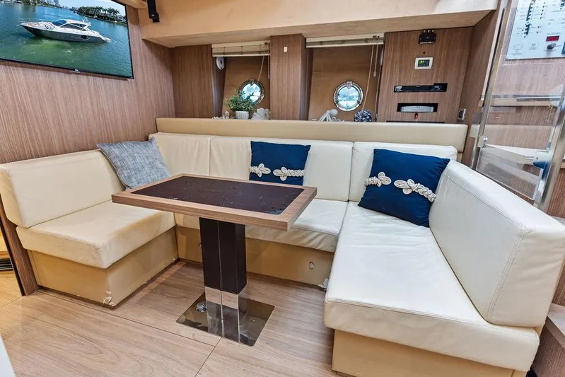 Minion Yacht Photos Pics Luxurious interior of 2014 Cranchi 56 HT yacht with elegant seating and table.