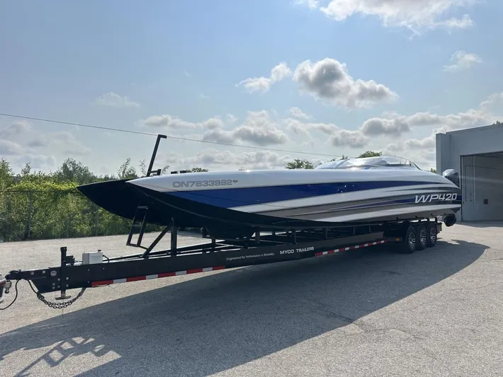  Yacht Photos Pics 2018 Wright Performance 420 boat on trailer, parked outdoors under a partly cloudy sky.