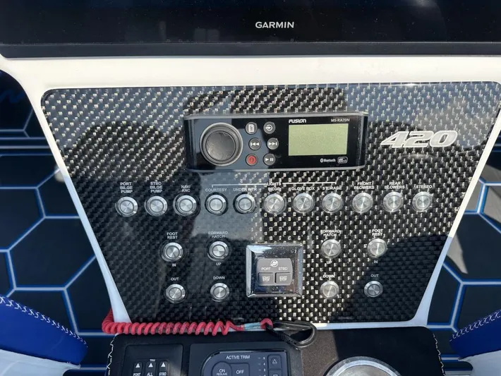  Yacht Photos Pics Control panel of 2018 Wright Performance 420 boat with carbon fiber finish and various switches.