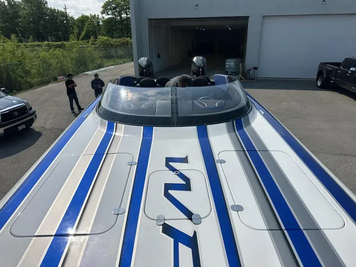  Yacht Photos Pics 2018 Wright Performance 420 boat with blue and gray stripes, parked outside a garage.