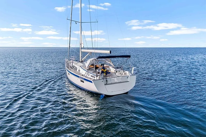  Yacht Photos Pics 2022 Hallberg-Rassy 400 sailboat on open sea under clear blue sky.