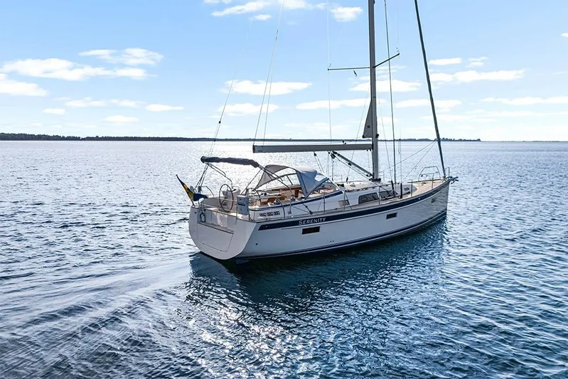  Yacht Photos Pics 2022 Hallberg-Rassy 400 sailboat on calm blue water under clear sky.