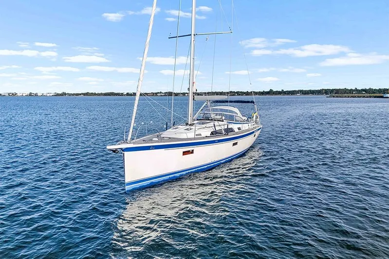  Yacht Photos Pics 2022 Hallberg-Rassy 400 sailboat cruising on open water under clear skies.