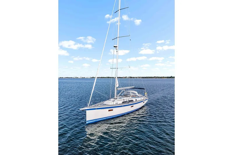  Yacht Photos Pics 2022 Hallberg-Rassy 400 sailboat on calm blue water under clear sky.