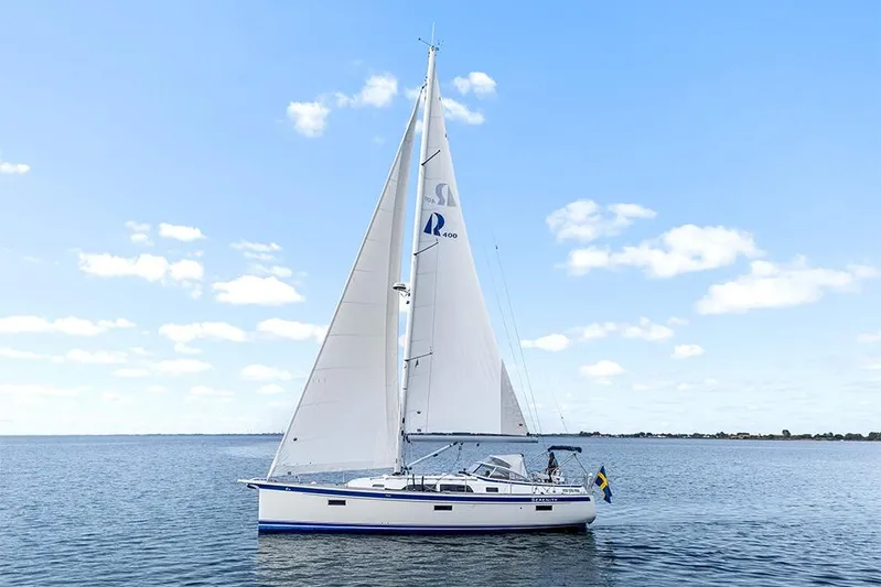  Yacht Photos Pics 2022 Hallberg-Rassy 400 sailboat on calm water under blue sky.