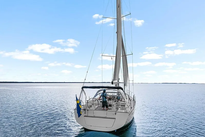  Yacht Photos Pics 2022 Hallberg-Rassy 400 sailboat on calm sea under clear blue sky.