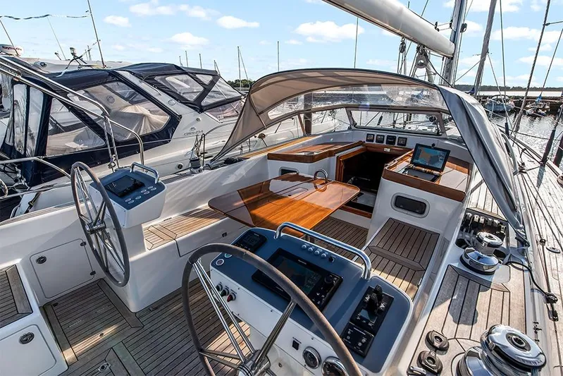  Yacht Photos Pics 2022 Hallberg-Rassy 400 yacht cockpit with dual steering wheels and navigation equipment.