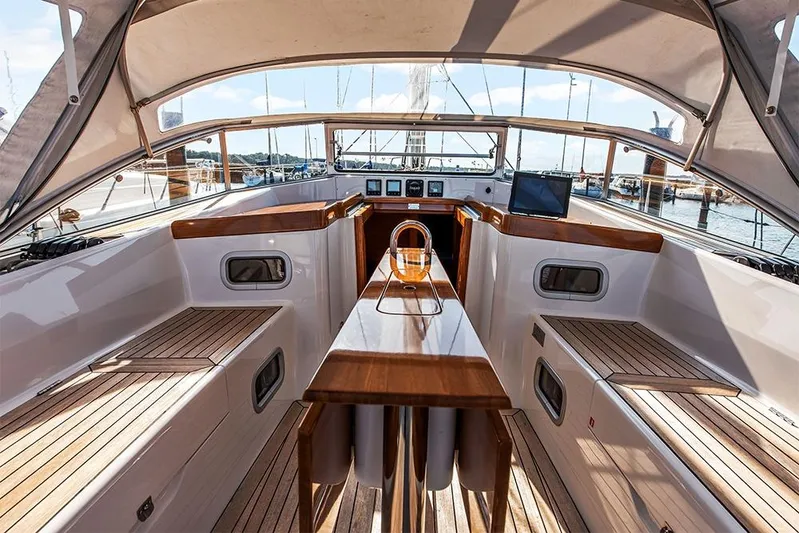  Yacht Photos Pics Cockpit of 2022 Hallberg-Rassy 400 yacht with wooden seating and navigation equipment.