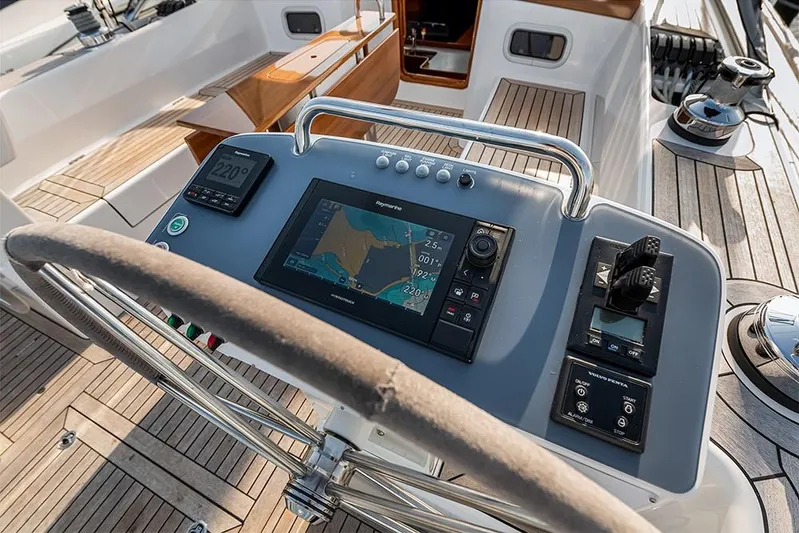  Yacht Photos Pics Steering console of 2022 Hallberg-Rassy 400 yacht with navigation equipment.