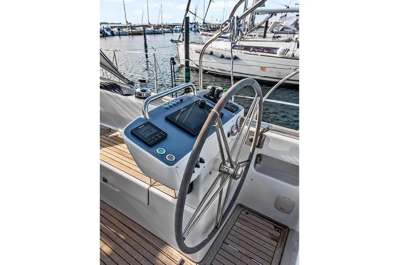  Yacht Photos Pics Steering wheel and controls of 2022 Hallberg-Rassy 400 yacht, docked at marina.