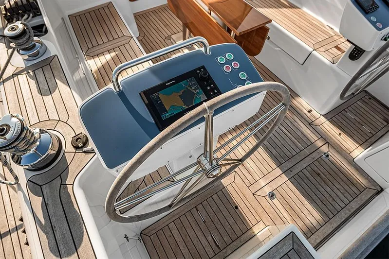  Yacht Photos Pics Cockpit of 2022 Hallberg-Rassy 400 yacht with navigation system and wooden deck.