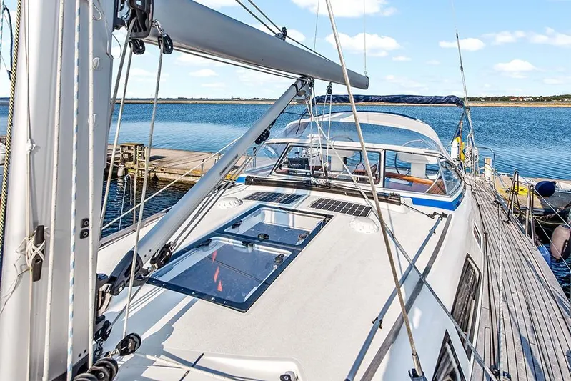  Yacht Photos Pics 2022 Hallberg-Rassy 400 yacht docked by the water, showcasing sleek design and modern features.