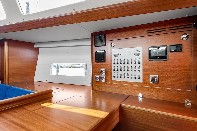  Yacht Photos Pics Interior control panel of 2022 Hallberg-Rassy 400 yacht with wooden finish.