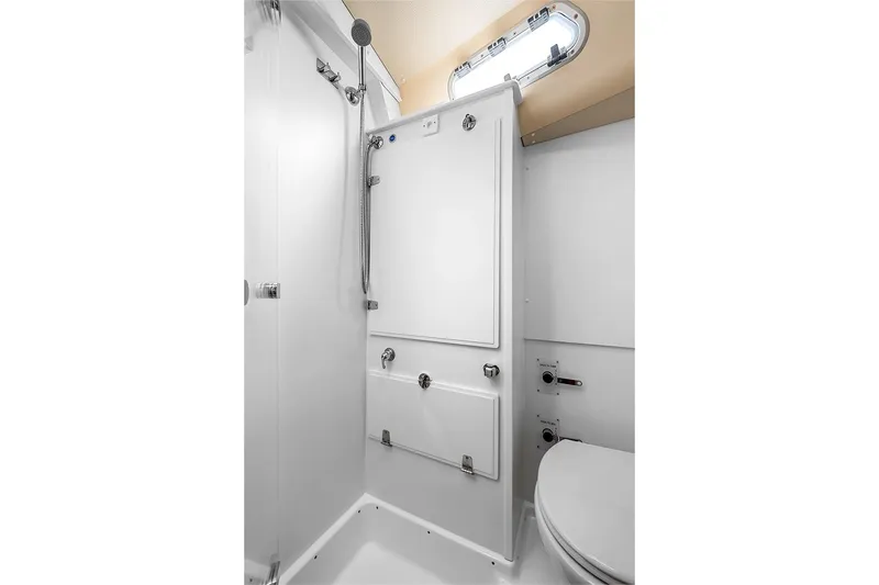  Yacht Photos Pics Modern bathroom interior of 2022 Hallberg-Rassy 400 yacht, featuring shower and toilet.