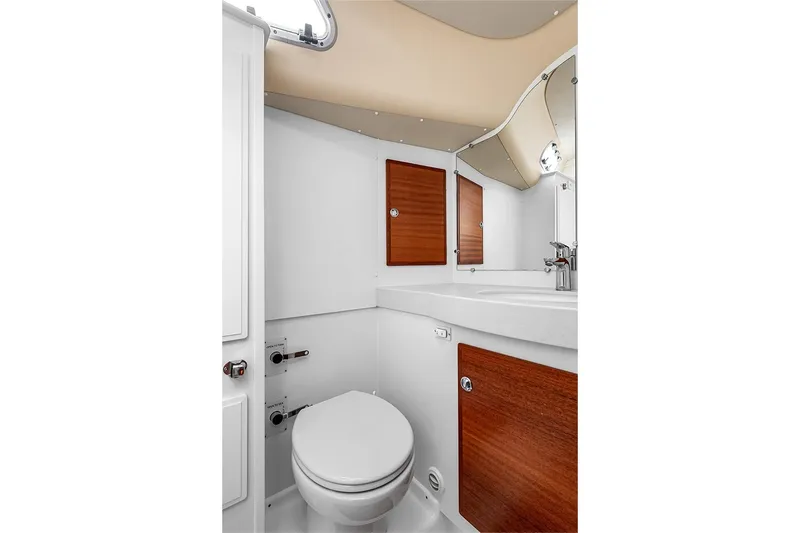 Yacht Photos Pics Modern bathroom in 2022 Hallberg-Rassy 400 yacht with sleek fixtures and wooden accents.