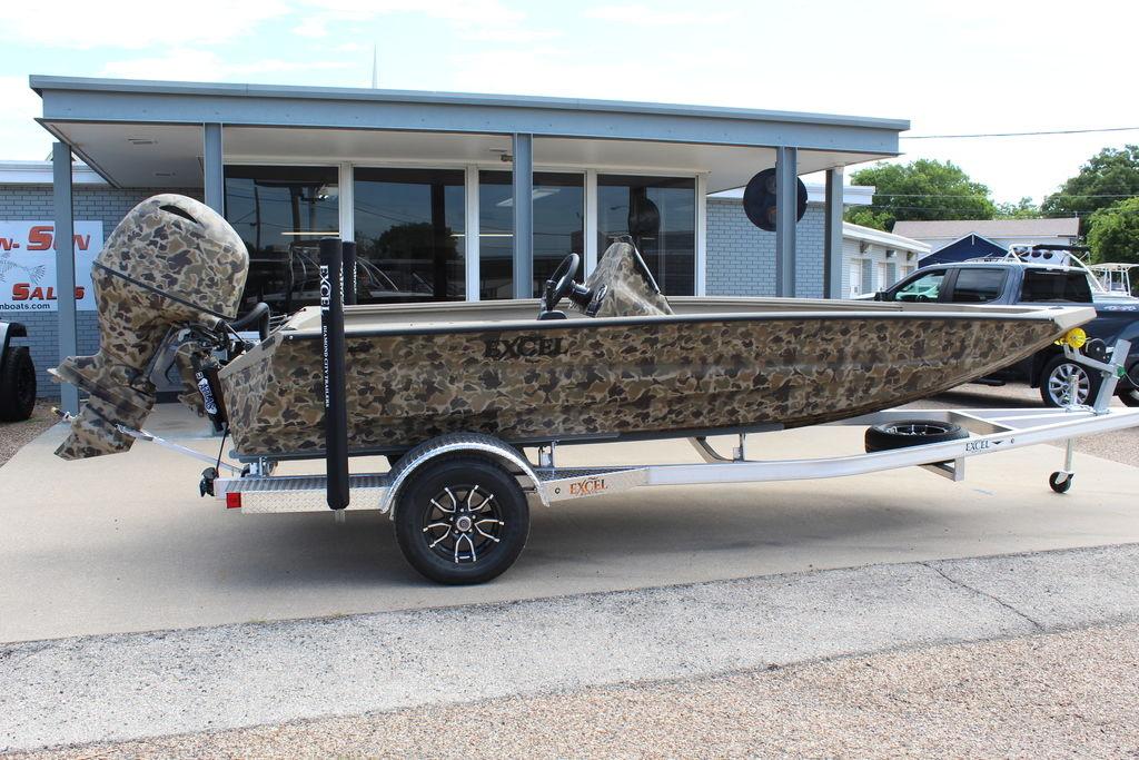2026 Excel Bolt 183 boat with camouflage design on a trailer outside a dealership.