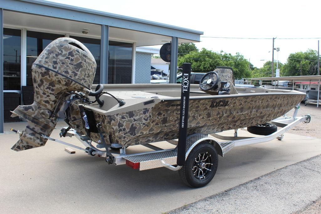 2026 Excel Bolt 183 boat with camouflage design on a trailer, parked outdoors.