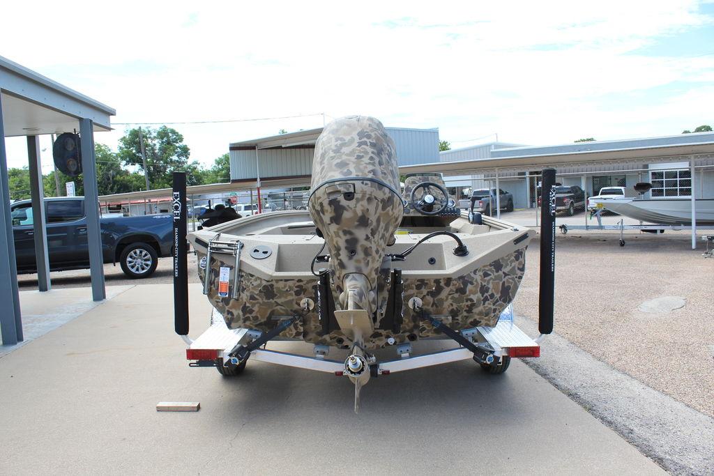 2026 Excel Bolt 183 boat with camouflage design on a trailer in a dealership lot.
