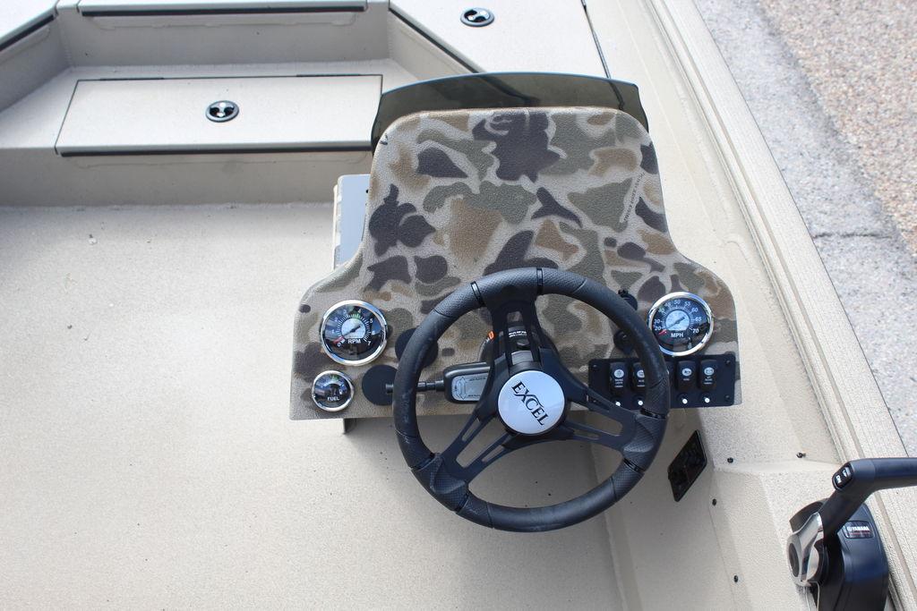 2026 Excel Bolt 183 boat dashboard with camo design and steering wheel.