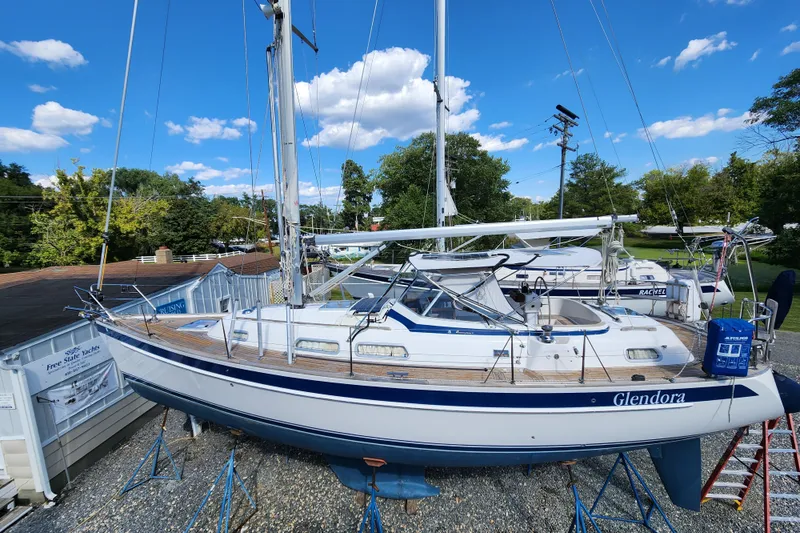 Glendora Yacht Photos Pics 2007 Hallberg-Rassy 37 sailboat on stands, clear sky, lush greenery background.