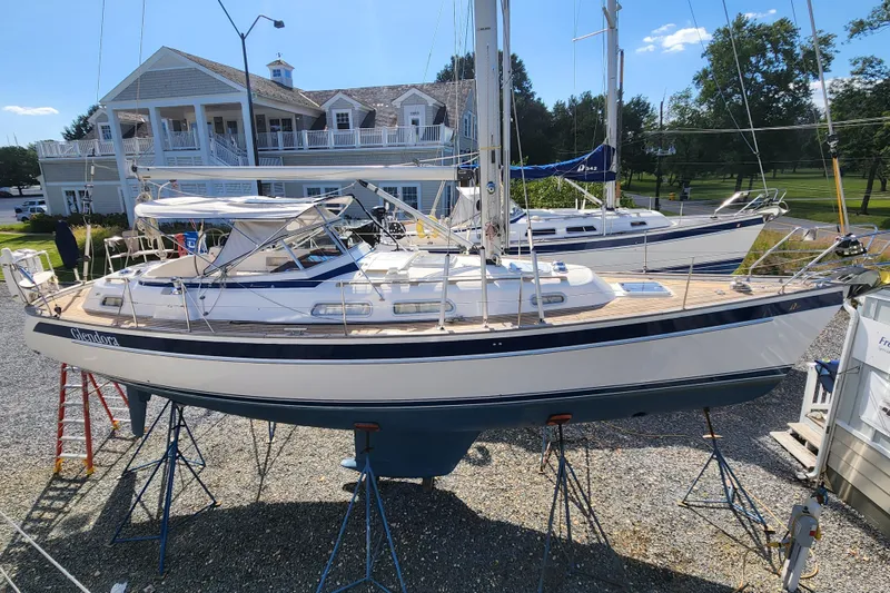 Glendora Yacht Photos Pics 2007 Hallberg-Rassy 37 sailboat on stands, near a marina building.