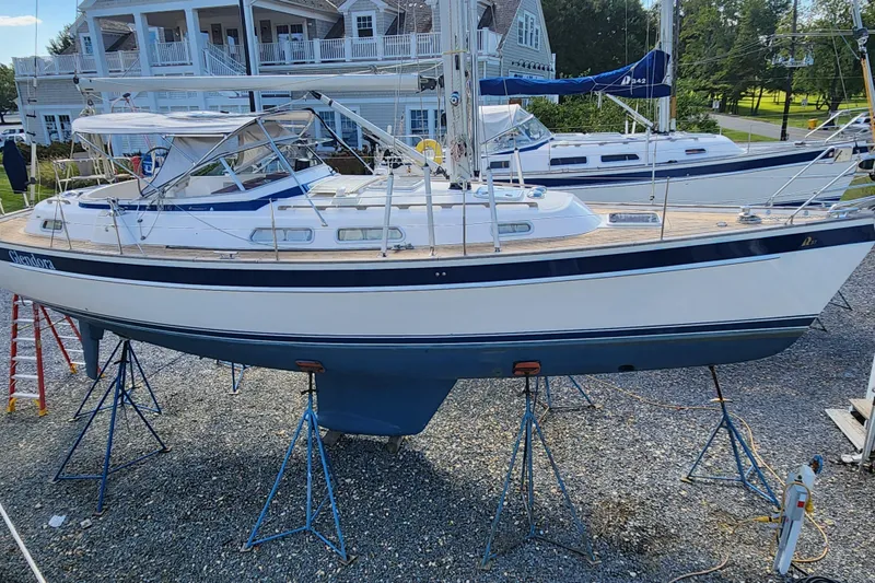 Glendora Yacht Photos Pics 2007 Hallberg-Rassy 37 sailboat on stands, with a scenic marina backdrop.