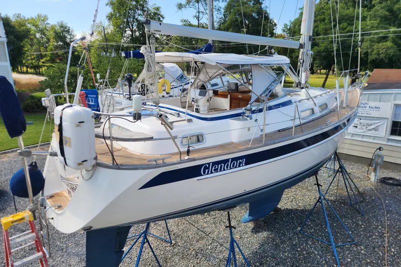 Glendora Yacht Photos Pics 2007 Hallberg-Rassy 37 sailboat on stands, named Glendora, in a yard setting.