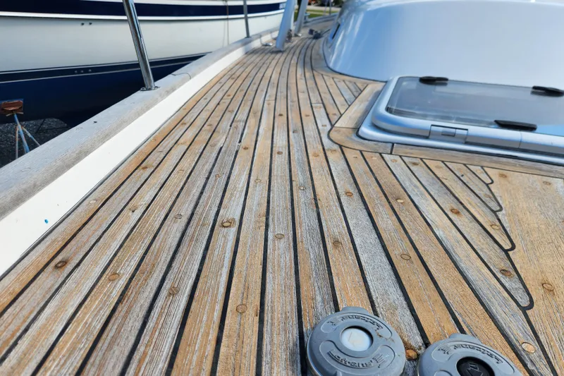 Glendora Yacht Photos Pics Teak deck of 2007 Hallberg-Rassy 37 sailboat, showcasing elegant wood grain and craftsmanship.