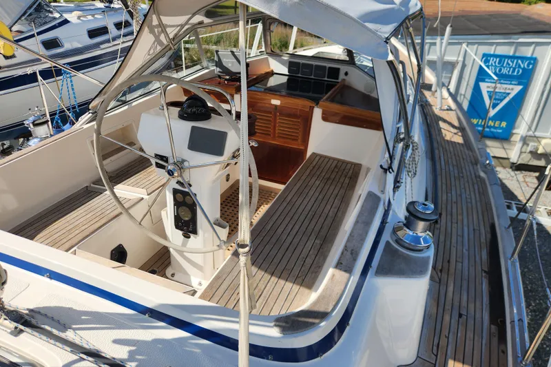 Glendora Yacht Photos Pics 2007 Hallberg-Rassy 37 sailboat cockpit with wooden deck and steering wheel.