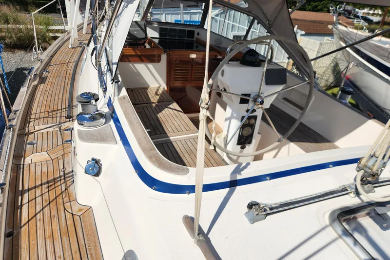 Glendora Yacht Photos Pics 2007 Hallberg-Rassy 37 sailboat cockpit with wooden deck and steering wheel.
