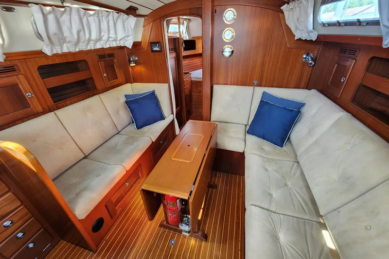 Glendora Yacht Photos Pics Luxurious 2007 Hallberg-Rassy 37 yacht interior with plush seating and elegant wood finish.