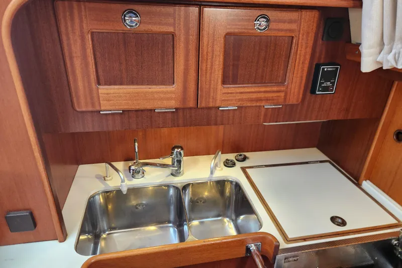 Glendora Yacht Photos Pics Galley of 2007 Hallberg-Rassy 37 yacht with wooden cabinets and double sink.