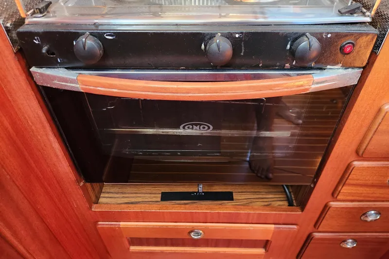 Glendora Yacht Photos Pics Built-in oven in 2007 Hallberg-Rassy 37 yacht kitchen, featuring wooden cabinetry.