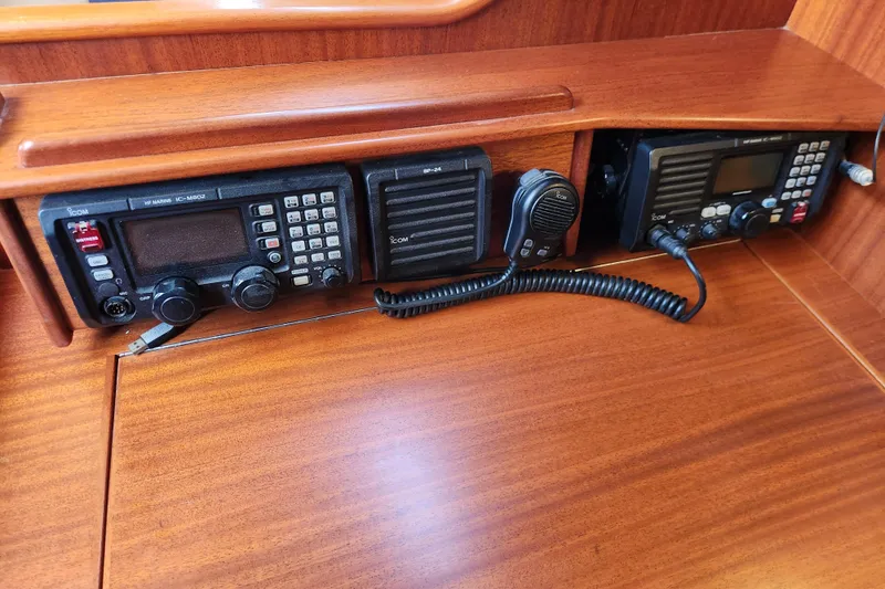 Glendora Yacht Photos Pics 2007 Hallberg-Rassy 37 yacht radio equipment with Icom communication devices on wooden panel.
