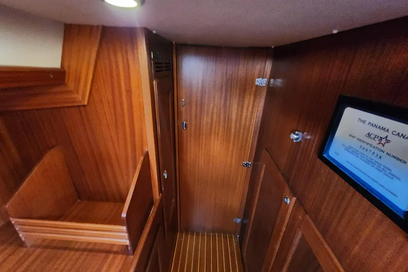 Glendora Yacht Photos Pics Interior of 2007 Hallberg-Rassy 37 yacht with wooden paneling and Panama Canal certificate.