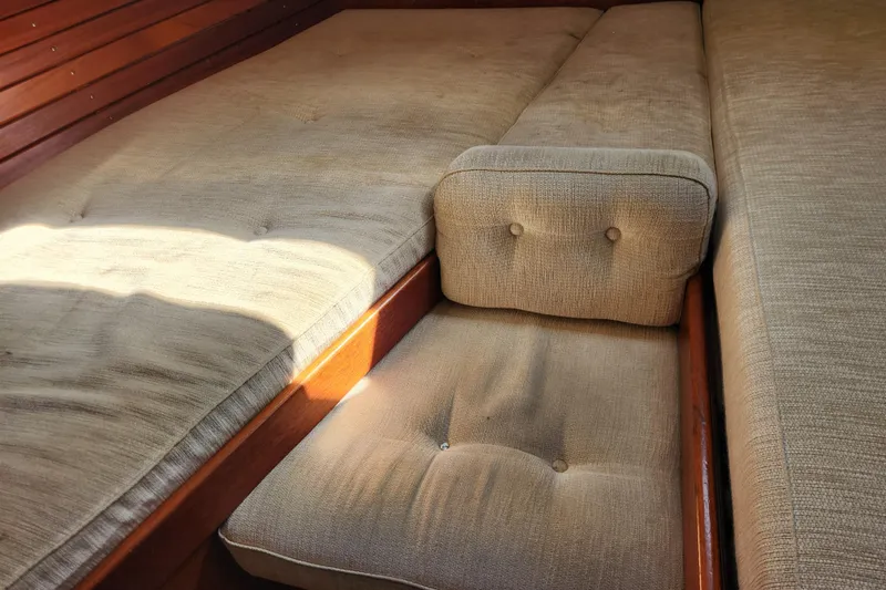 Glendora Yacht Photos Pics Interior of 2007 Hallberg-Rassy 37 yacht with beige cushioned seating.