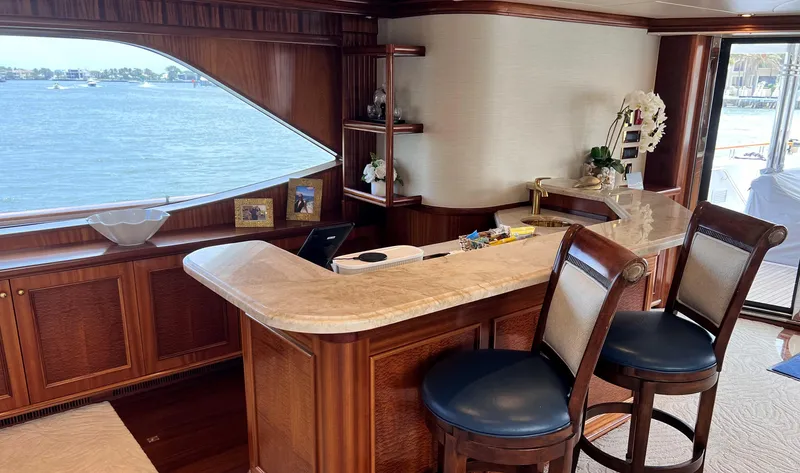 Miss Stephanie Yacht Photos Pics Luxurious yacht interior with wooden bar, stools, and ocean view. Richmond Yachts Semi-Displacement, 2004.