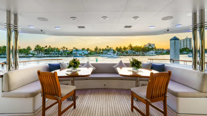 Miss Stephanie Yacht Photos Pics Luxurious 2004 Richmond Yachts semi-displacement yacht with elegant outdoor seating and scenic sunset view.