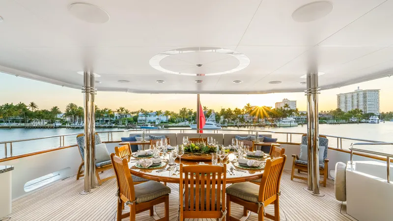 Miss Stephanie Yacht Photos Pics Luxurious dining area on 2004 Richmond Yachts Semi-Displacement, overlooking serene waterfront at sunset.