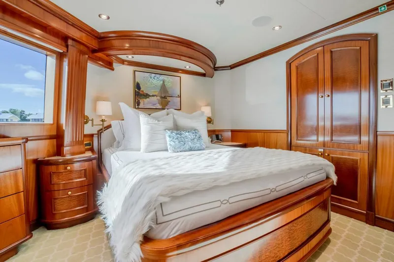 Miss Stephanie Yacht Photos Pics Luxurious bedroom interior on 2004 Richmond Yachts Semi-Displacement, featuring elegant wood finishes.