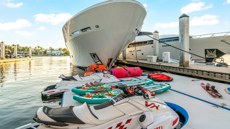 Miss Stephanie Yacht Photos Pics Luxury Richmond Yachts 2004 docked with jet skis and paddleboards nearby.