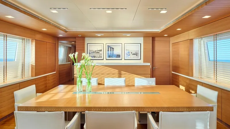 Kintaro Yacht Photos Pics Luxurious dining area on 2005 Cantieri di Pisa Akhir 38 yacht, featuring elegant wood paneling.