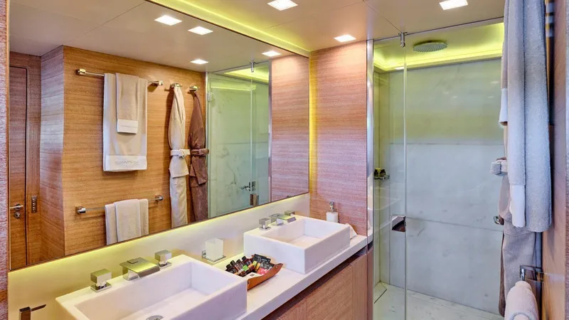 Kintaro Yacht Photos Pics Luxurious bathroom on 2005 Cantieri di Pisa Akhir 38 yacht with dual sinks and glass shower.