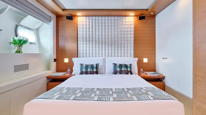 Kintaro Yacht Photos Pics Luxurious bedroom interior on 2005 Cantieri di Pisa Akhir 38 yacht, featuring modern design and elegant decor.