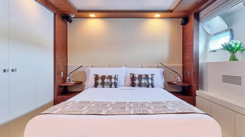 Kintaro Yacht Photos Pics Luxurious bedroom interior on 2005 Cantieri di Pisa Akhir 38 yacht, featuring elegant design and cozy ambiance.