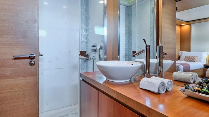 Kintaro Yacht Photos Pics Luxurious bathroom interior on 2005 Cantieri di Pisa Akhir 38 yacht, featuring modern sink and shower.