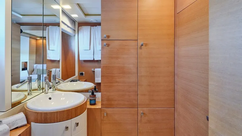 Kintaro Yacht Photos Pics Luxurious bathroom on 2005 Cantieri di Pisa Akhir 38 yacht with modern wood cabinetry.