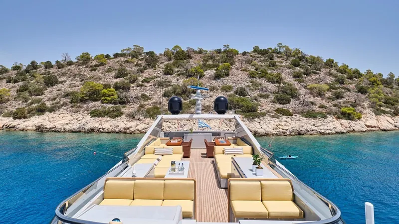 Kintaro Yacht Photos Pics Luxurious 2005 Cantieri di Pisa Akhir 38 yacht with elegant deck, anchored near scenic coastline.