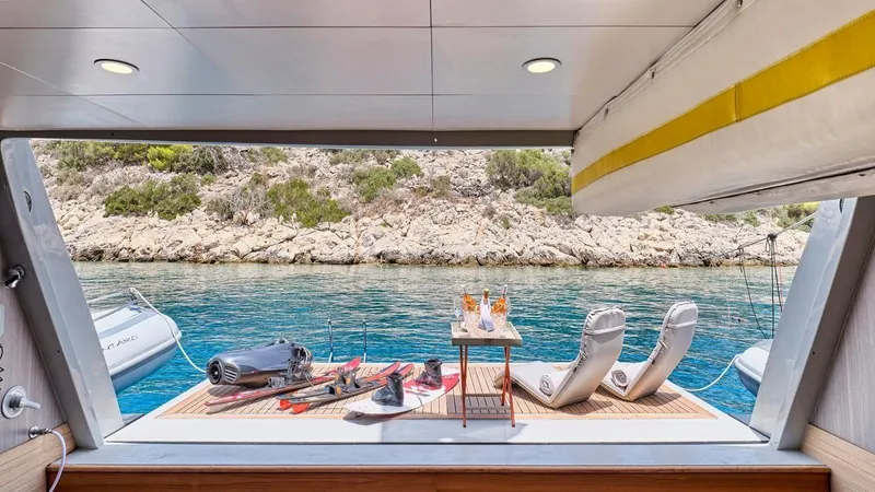 Kintaro Yacht Photos Pics Luxury yacht deck with water sports gear, lounge chairs, and drinks, Cantieri di Pisa Akhir 38, 2005.